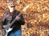 Frank Fogg playing bass guitar outside (from the Reaction 7 video 